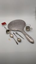 A liqueur con base together with a pair of silver tea spoons, a silver dressing table mirror and
