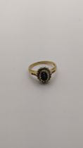 An 18ct gold ring set with a blue sapphire and diamonds 3.8g Location: