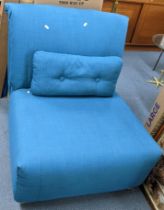 A modern turquoise upholstered single futon chair Location: