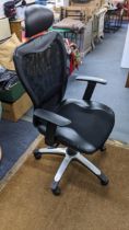 A faux black leather style desk chair Location: