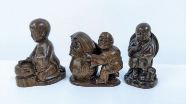 Three Chinese carved wooden netsukes, a kneeling boy, a boy with a dog, and another Location: