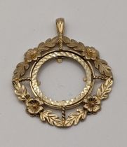 A 9ct gold sovereign holder pendant having floral design edges, 7.1g Location: