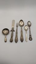 Mixed silver to include an embossed silver and mother of pearl letter opener, along with spoons, a