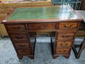 A modern reproduction twin pedestal mahogany desk with nine drawers, on bracket feet, 77cm x 91.