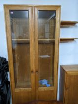 An Ercol Windsor style full height display cabinet, three glass interior shelves and twin glazed