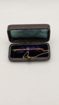 A late 19th/early 20th century 9ct gold stick pin inset with an amethyst 3.2g in a case Location: