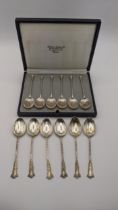 A cased set of six silver teaspoons together with five silver teaspoons having twisted stems, 99.