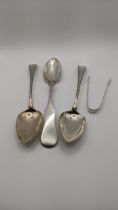A pair of silver table spoons hallmarked London 1804 together with a white metal tablespoon and a