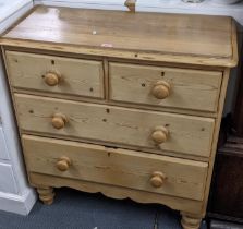 A pine chest of two short and two Tong drawers with bun shaped handles and turned legs95cm h x 89.