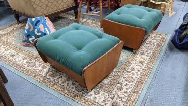 A pair of G-plan teak and green fabric upholstered stools on casters Location: