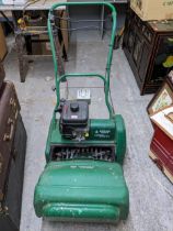 A Suffolk Punch cylinder petrol lawnmower with grass box, along with a boxed Qualcast Quick Exchange