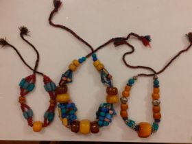 Three vintage Tibetan butterscotch amber and multi-coloured bead necklaces Location: RAB