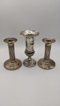 A pair of silver weighted candlesticks together with a silver weighted vase Location: