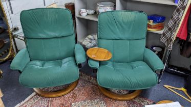 A pair of Stressless Ekorness green fabric upholstered armchairs, one with a table Location: