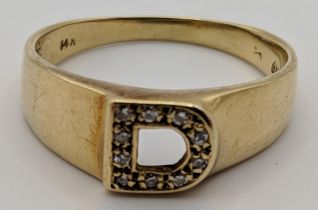 A gold ring set with diamonds in the shape of a D stamped 14k 5g Location: