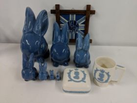 A collection of seven blue Denby models of seated rabbits, all of various sizes, a Delft blue and