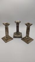 A pair of silver candlestick holders together with one other Location: