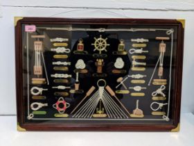 A glazed display wall hanging showing novelty marine equipment and accessories, and different