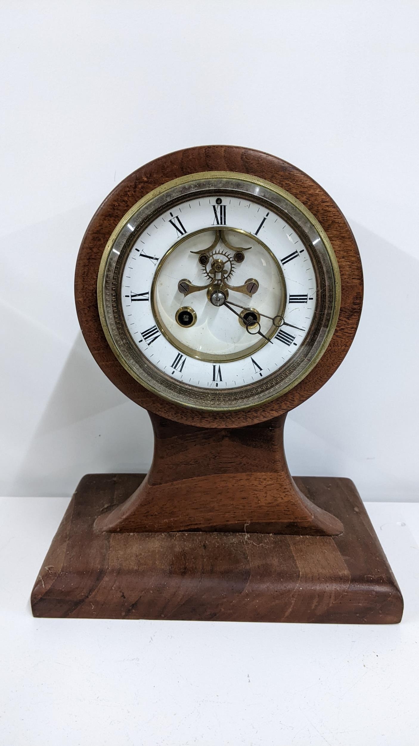 An early 20th century propellor mantel clock having a visible Brocot escapement with Breguet style