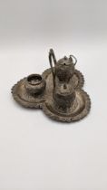 A white metal cruet set having floral embossed decoration, A/F, total weight 208.8g Location: