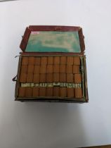 An early/mid century mah-jong set in a dark red leather carrying case Location: