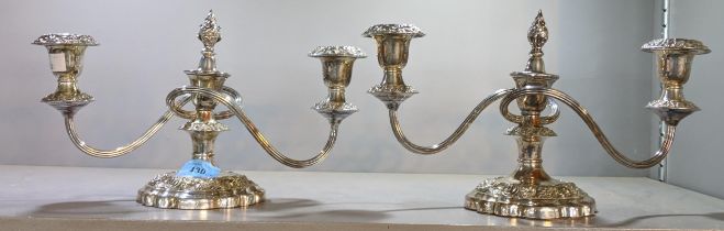 A pair of silver plated, twin handled candelabras on weighted elaborate bases, 18cm, Location: