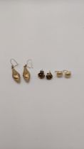 Three pairs of yellow metal earrings to include a pair fashioned as a rose and others, 6.1g