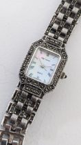 An Oleg Cassini ladies quartz silver wristwatch having a Mother of Pearl dial and diamante case