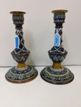 A pair of late 19th/early 20th century Royal Doulton Lambeth candlesticks with artist's monogram