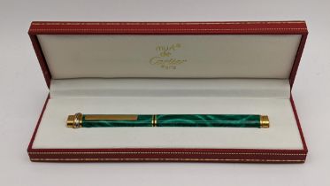 A Cartier malachite lacquer ballpoint pen, with box, numbered 610779 Location: