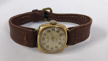 An early 20th century Everite 9ct gold manual wind wristwatch on a brown leather strap, Location: