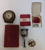 M G related items to include a workshop manual 1955, three badge and Smith clock, Location: