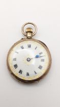An early 20th century gold keyless wound ladies fob watch having a white enamel dial with gilt