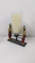 A painted metal candle holder fashioned as two water boys, Location: