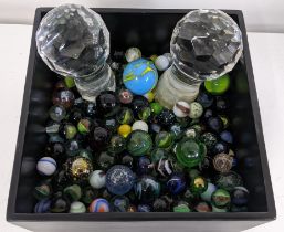 A selection of various loose marbles together with a pair of crystal cut decanter stoppers,