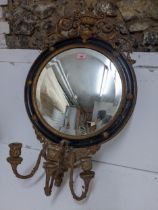 A 19th century gilt gesso wood and black girandole mirror, circular frame surmounted by scrolled