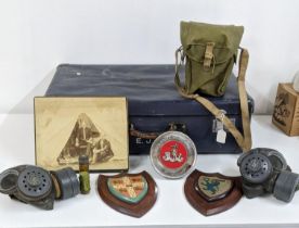 A mixed lot to include two WW2 Respirators along with two vintage shields and other housed in a blue