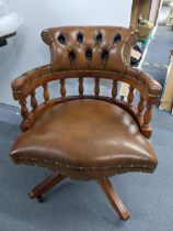 A reproduction brown leather button back Chesterfield swivel Captain's armchair Location: