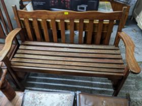 A wooden slatted garden bench 88 x 135 x 59cms Location: