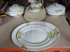 An early 20th century Falcon ware part dinner service decorated with fruit and leaves comprising