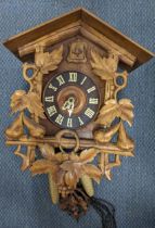 A black forest cuckoo clock, the heavily carved case in the form of a Swiss chalet Location: