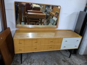 A mid century Meredew dressing table, swing mirror, base with six drawers, two finished in white, on