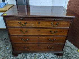 A Georgian mahogany veneered chest of drawers, brush slide above four graduated drawers on bracket