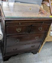 A mahogany bachelors chest of small proportions, cross branded top with glass panel, brush slide