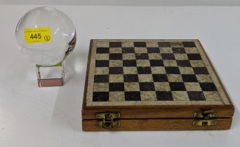 A rotating glass globe, and a carved stone chess set with a stone inset board Location: