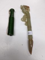 A Chinese green nephrite jade dragon headed pen ornament, and a green jade coloured stone cheroot