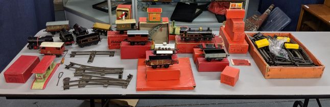 A collection of boxed and loose Hornby O gauge to include several engines, tracks, carriages and