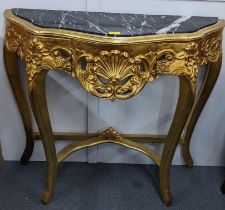 A reproduction Louis XVI style giltwood side table having a marble top and a carved serpentine