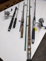 A group of four fishing rods, two with reels attached to include a Shakespeare Alpha x 030 Location: