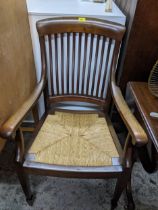 Late 19th/early 20th century mahogany rush seated armchair on square tapering legs and spade feet